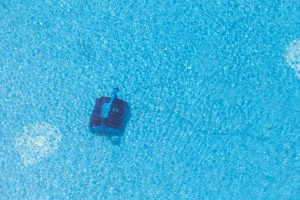 Robot cleaning a swimming pool, under water